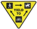 yellow triangular sign depicting trail etiquette: Hikers yield to horses, and bikes yield to everyone